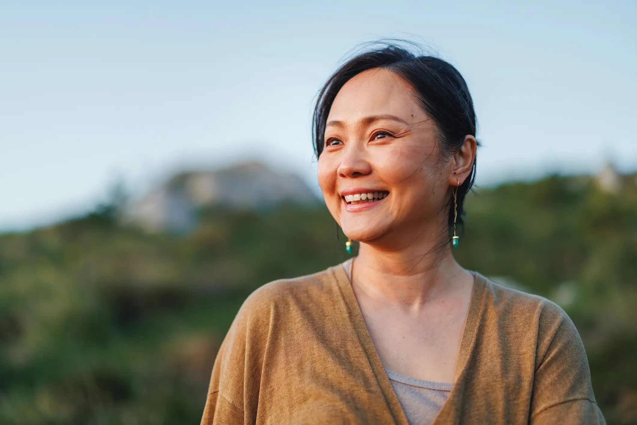 Woman with earings in tan top